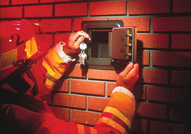 A firefighter opening a Knox Box to gain access to a commercial business