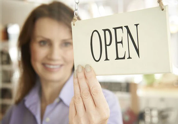 A small business owner opening her shop for the day