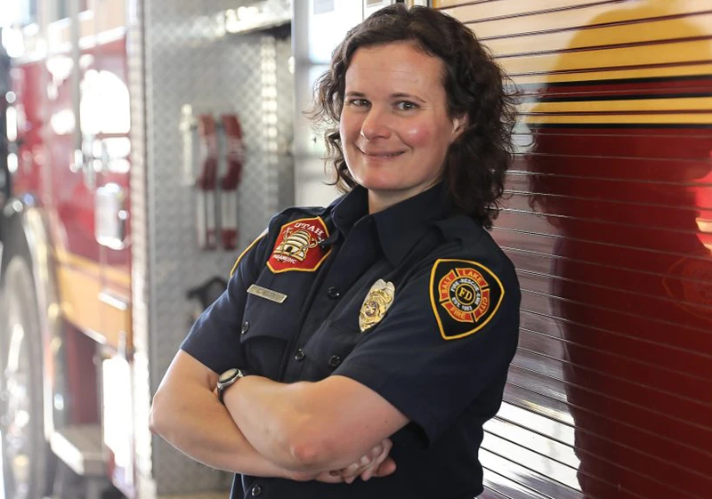 A salt lake city firefighters posing next to a fire truck