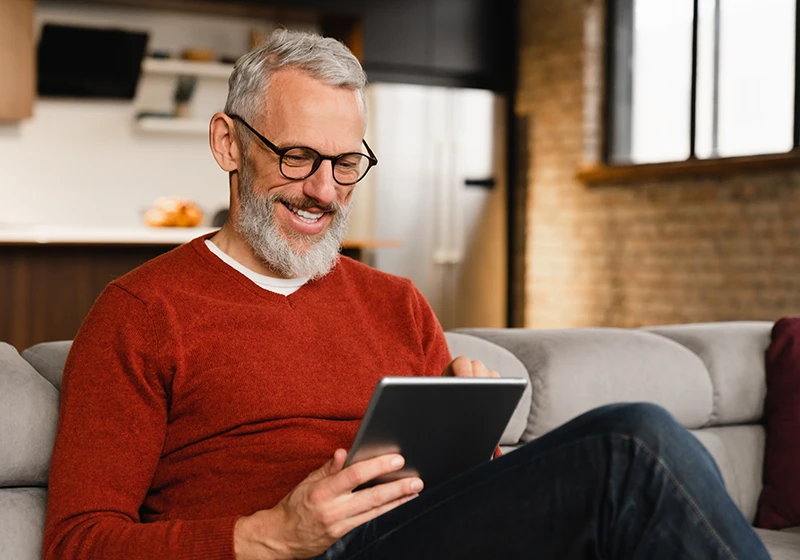 A man reading an electronic newsletter on a tablet